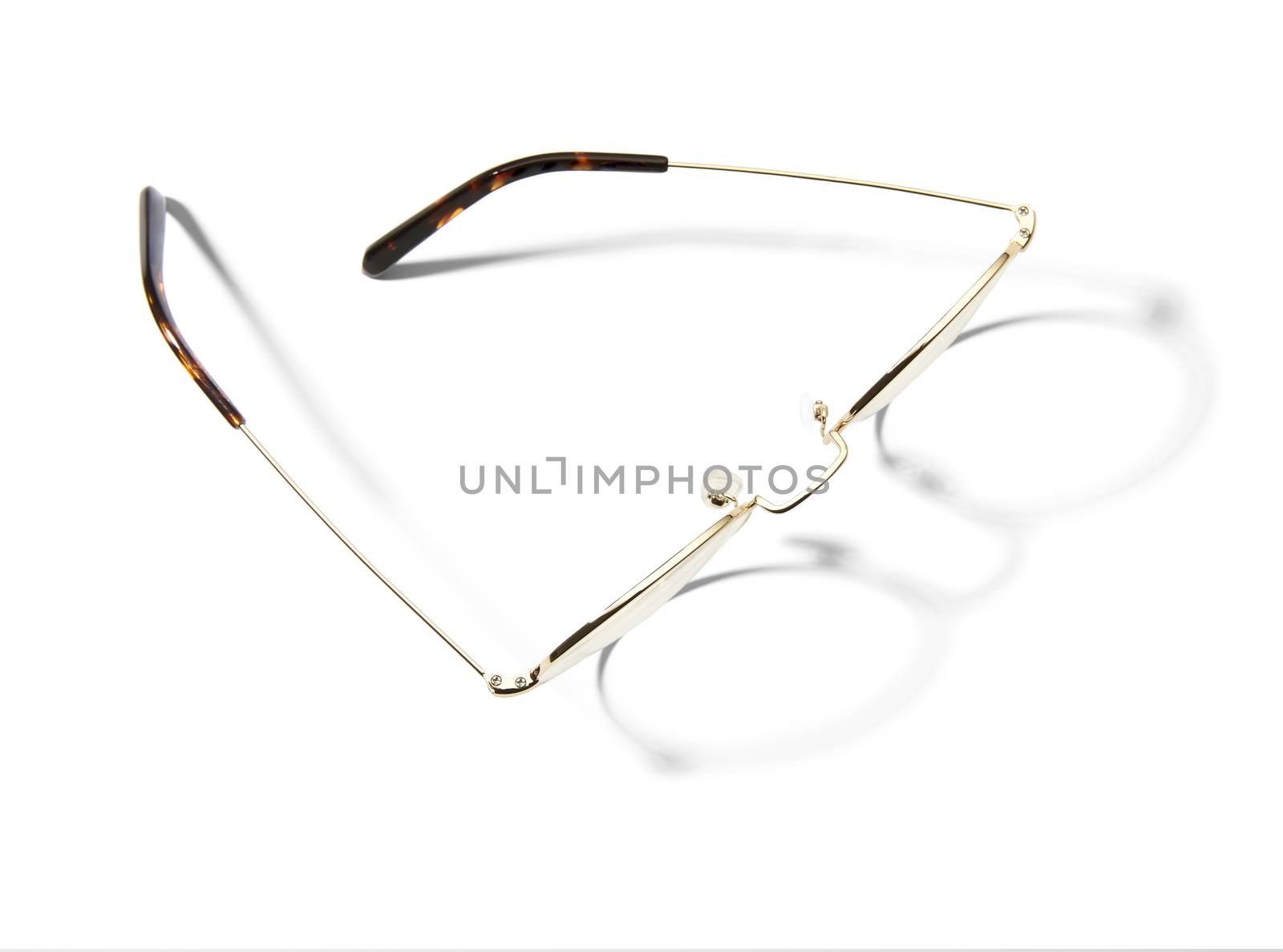 Studio shot of pair of eyeglasses on white background with shadow. 