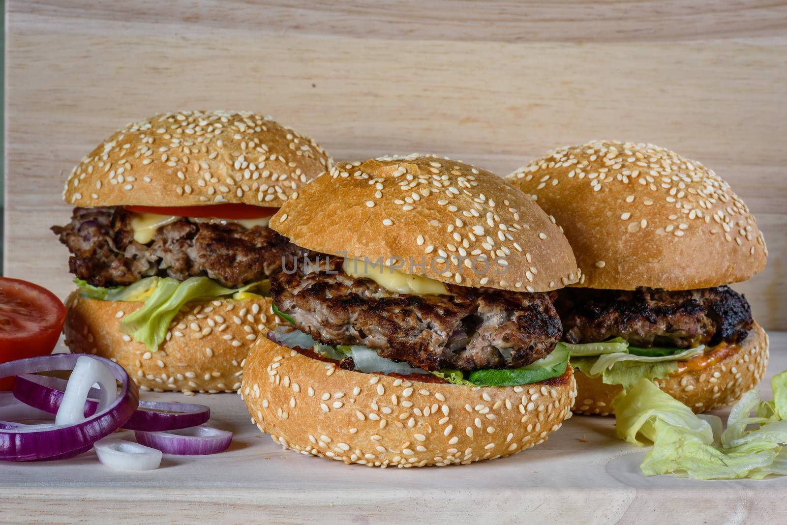 Three fresh hamburger lay on the board. Homemade fast food more tasty and healthy.