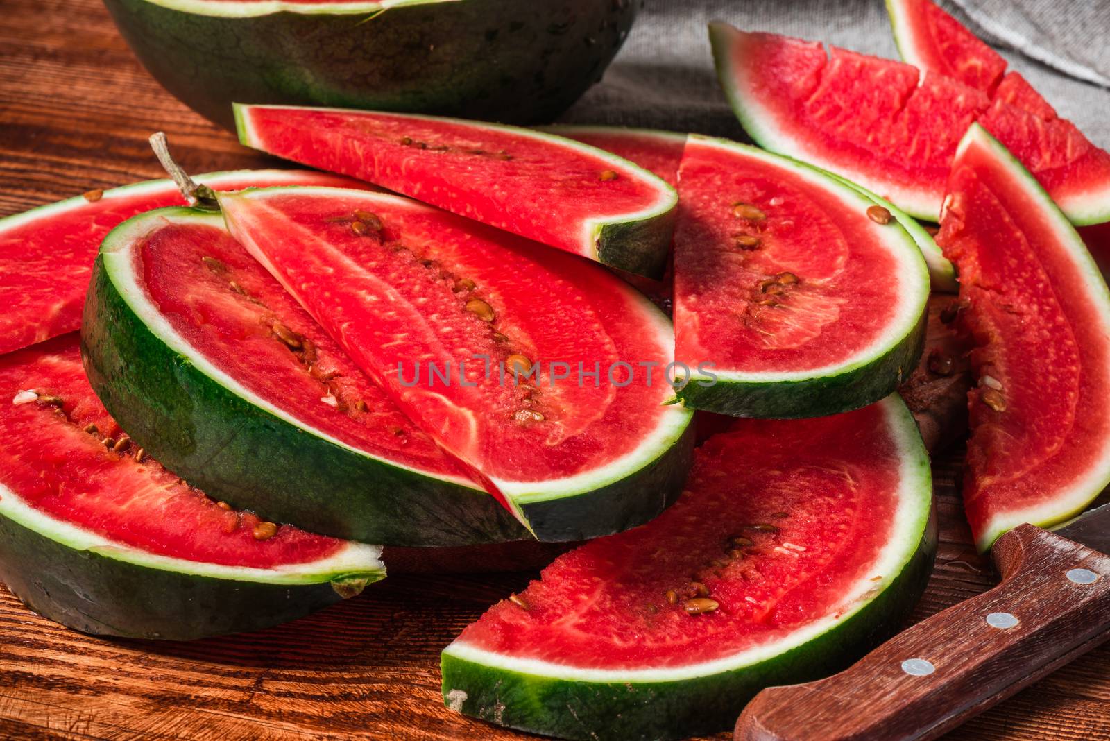 Watermelon slices lying on wooden table. Summer juicy dessert.