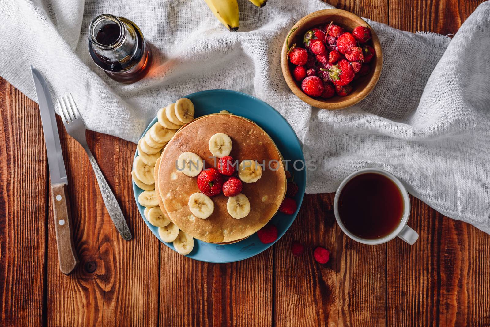 Breakfast with Homemade Pancakes, Fruits and Cup of Tea. View from Above.