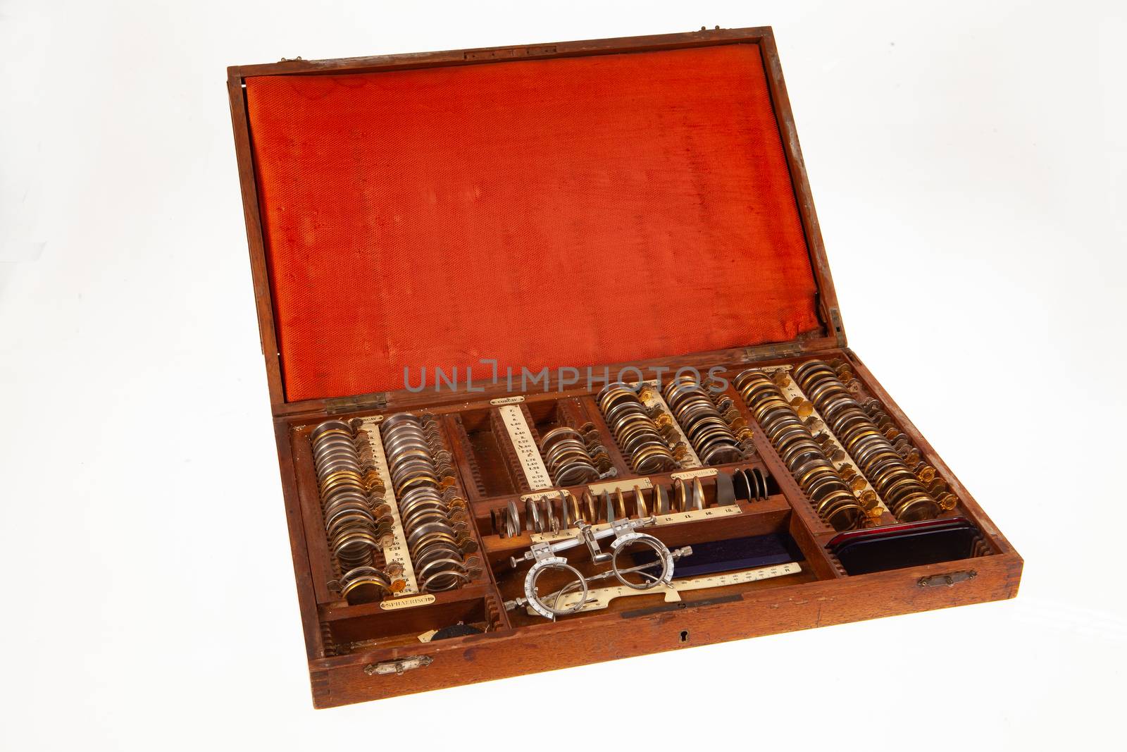 Old optometric set of lenses on isolated studio background