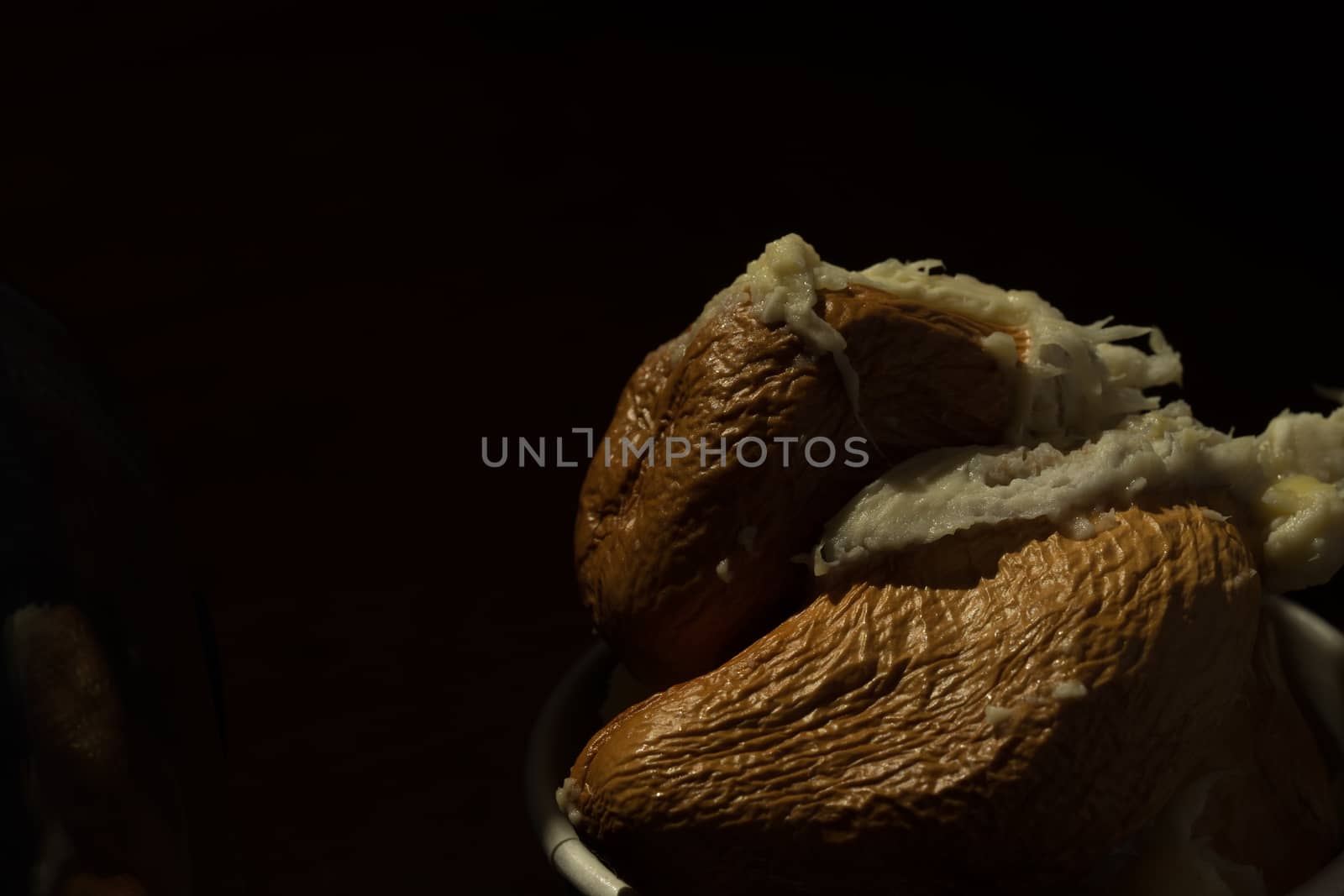 Close up Durian seeds after eating meat. Black background makes  by sakchaineung