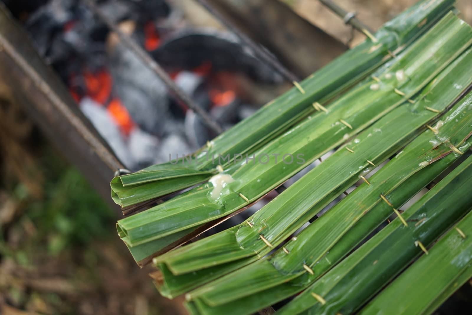 sticky rice with coconut in palm leaf. Traditional Thai desserts by sakchaineung