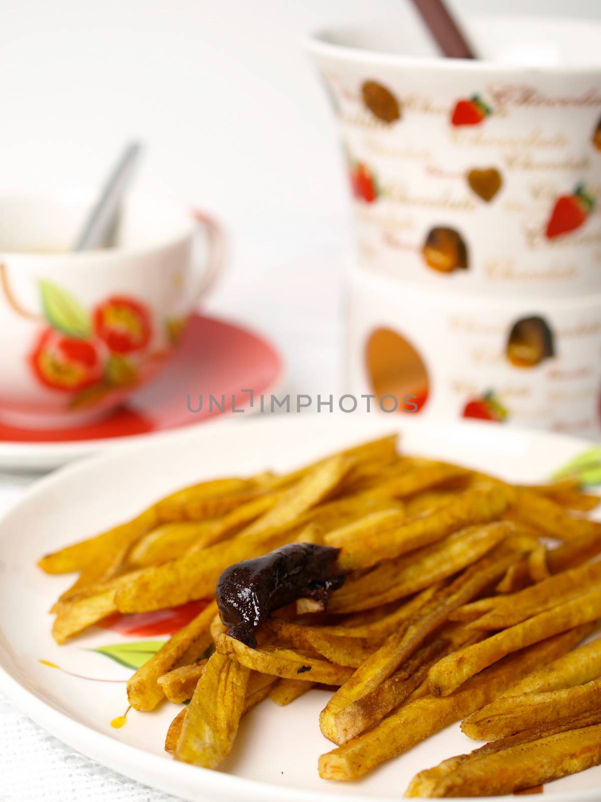 Homemade potatoes chips with chocolate fondue on white background