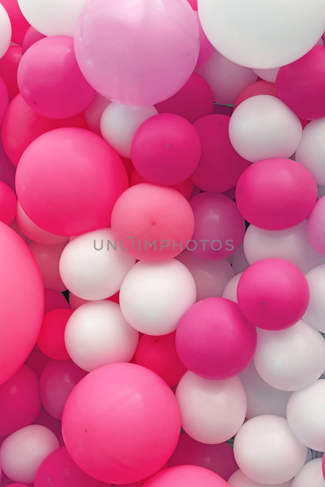 Close up festive background of purple pink and white air balloons of different sizes