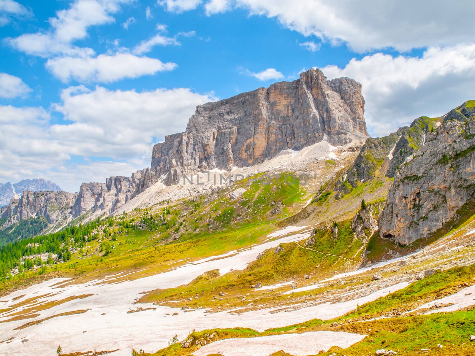 Lastoni de Formin, aka Ponta Lastoi de Formin. Giant mountain block with blooing meadow and summer sky, Dolomites, Italy by pyty