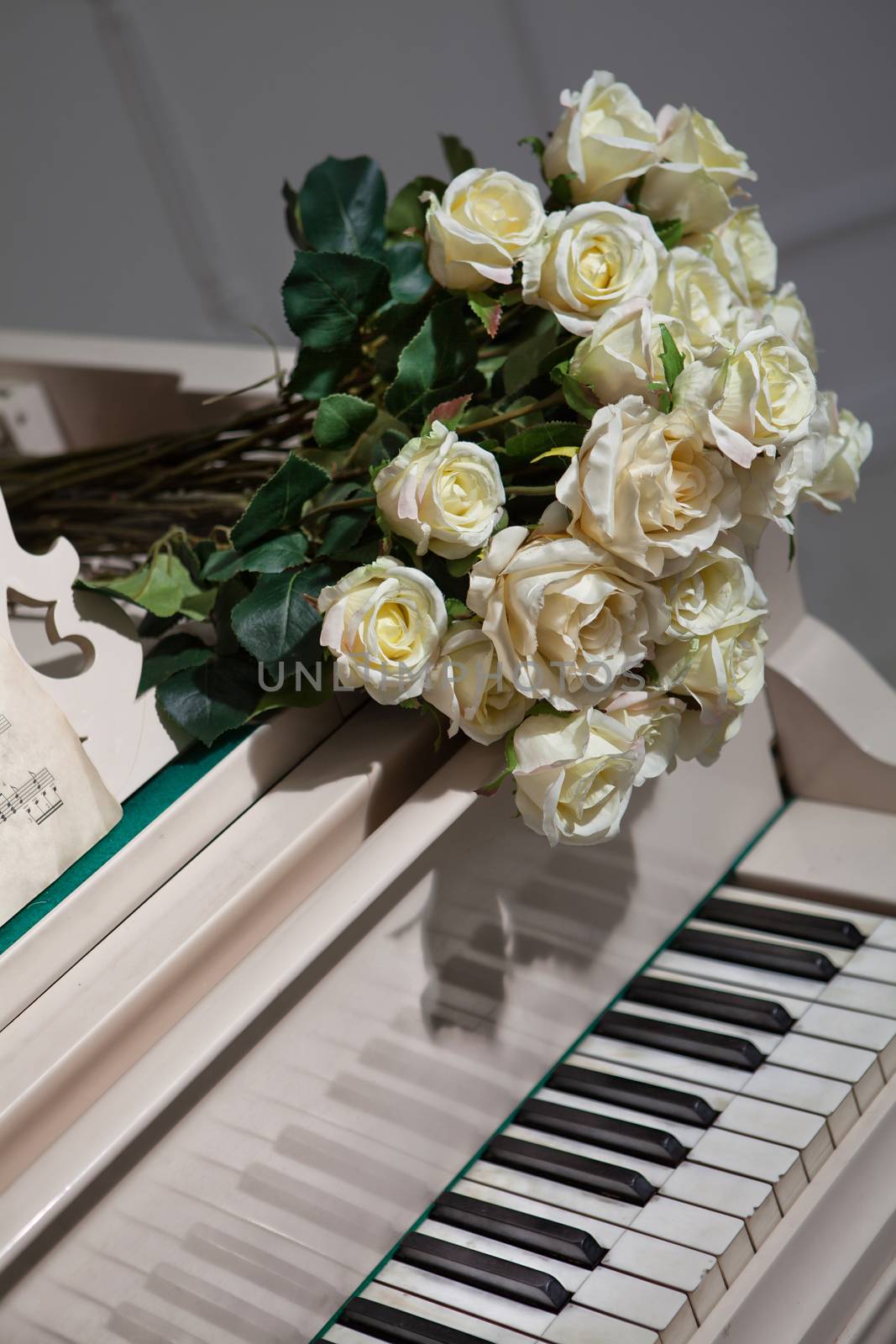 Bouguet of roses on grand piano keyboard