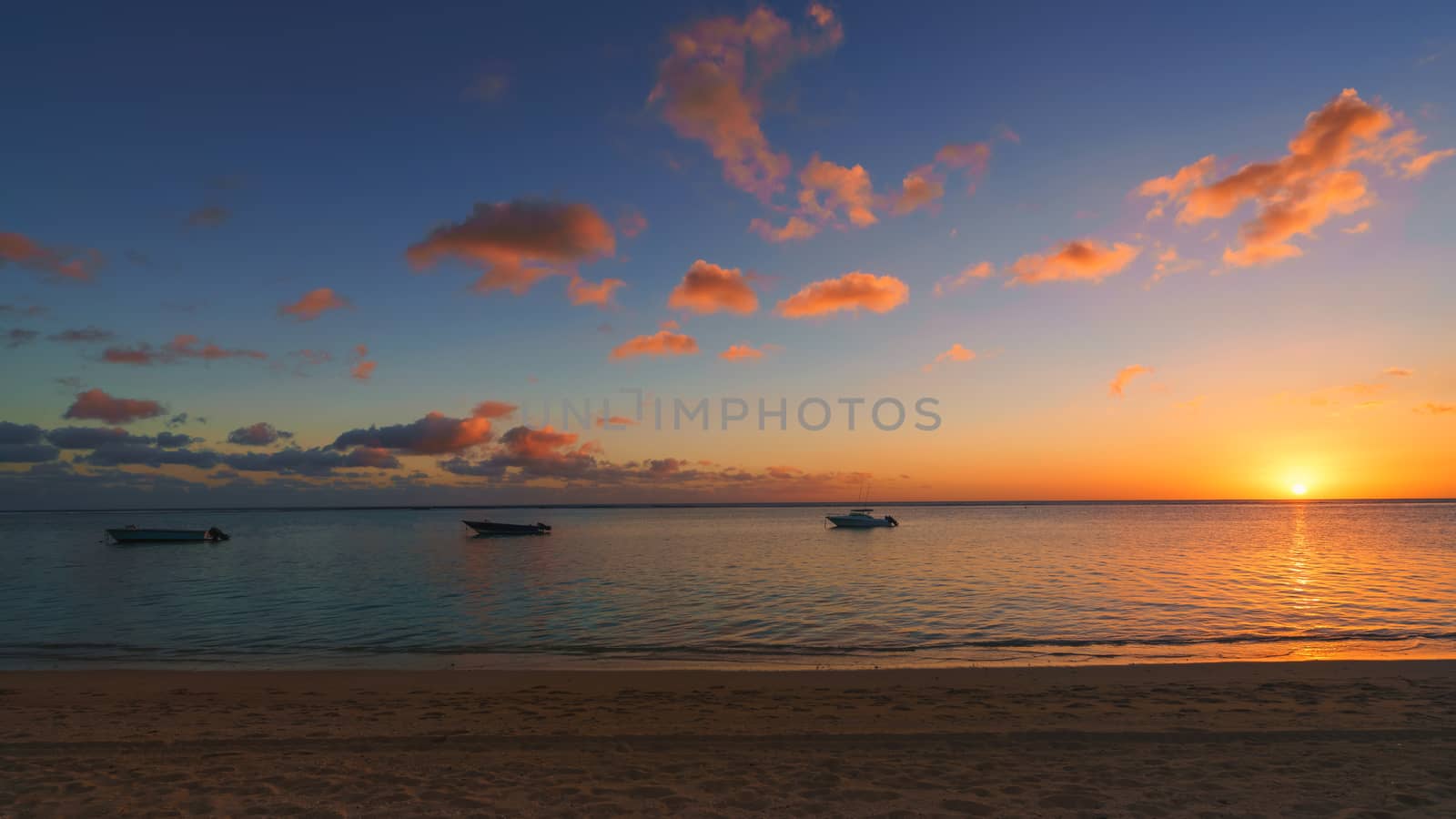 Amazing sunset at Mauritius panorama,Fishing boat at sunset time.