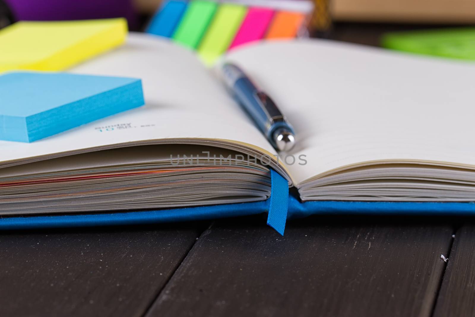 Planning your day, A day blank day planner with a blue pen