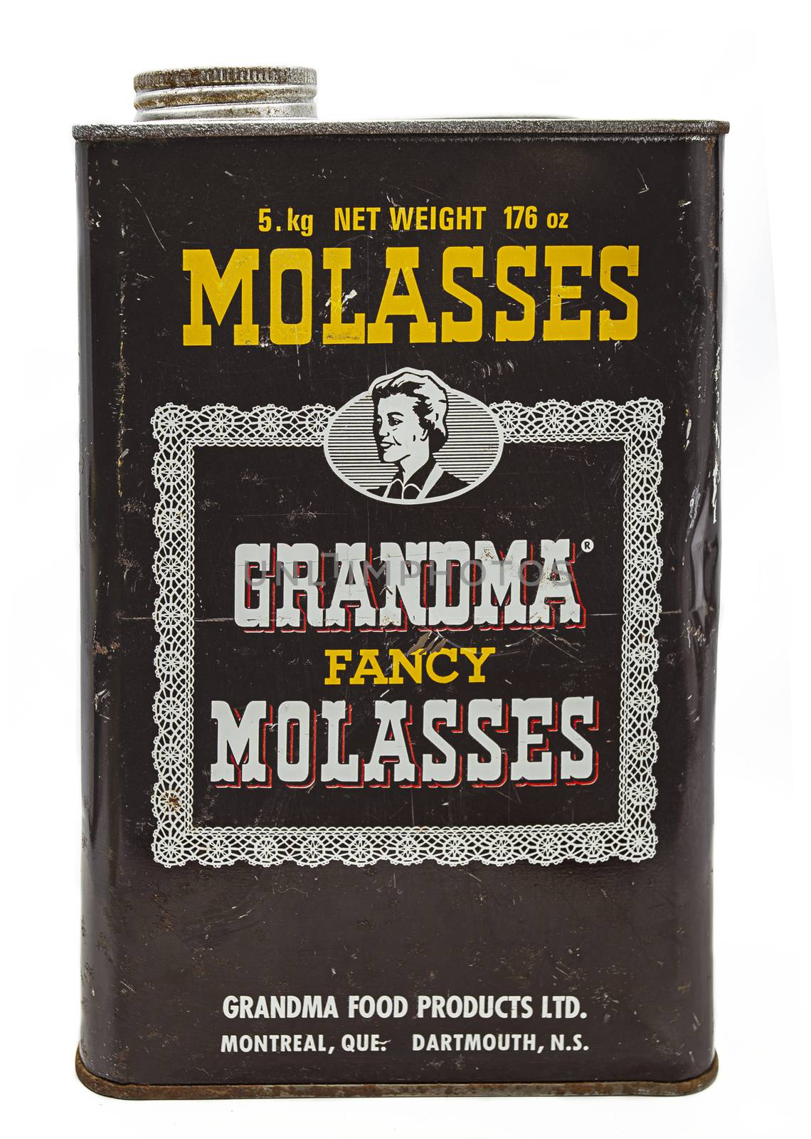 metal box of molasses against a white background