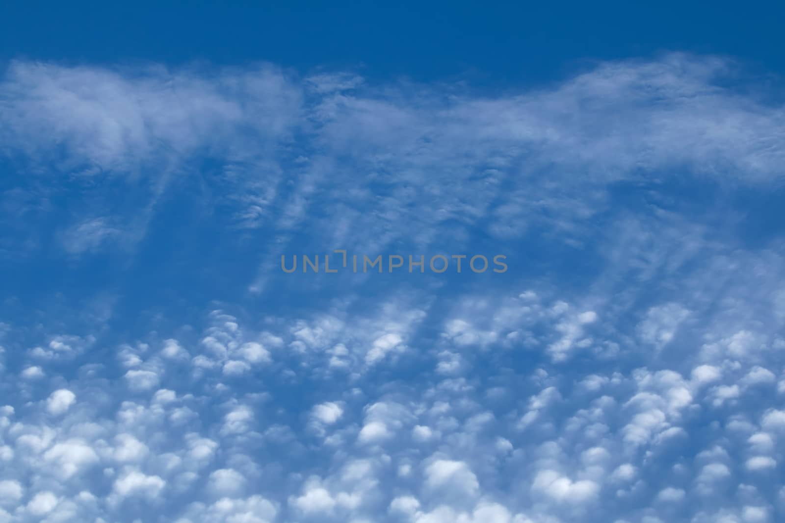 Streaky and puffy Cirrocumulus Clouds against blue sky. Landscape orientation.
