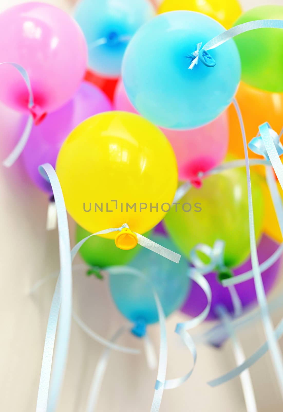 Bunch of floating colored balloons and strings at party