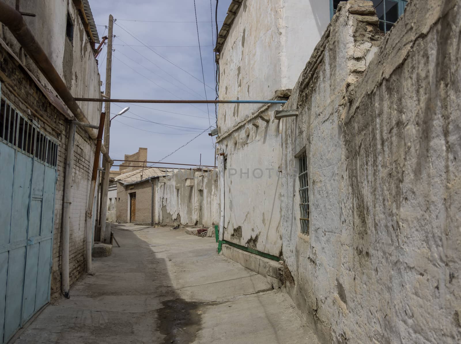 Narrow street of Itchan Kala medieval residential neighborhoods, Khiva, Uzbekistan.