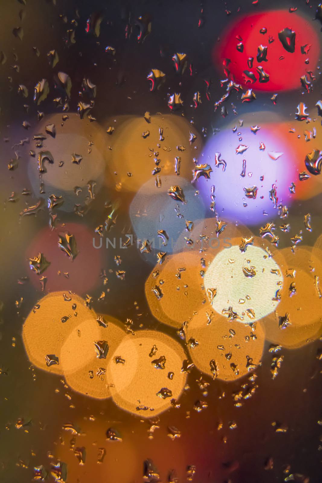 Water drops on window with color background