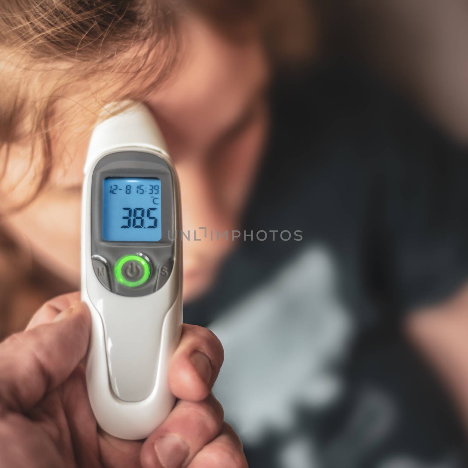 A Parent Using A Digital Thermometer To Take A Child's Temperature