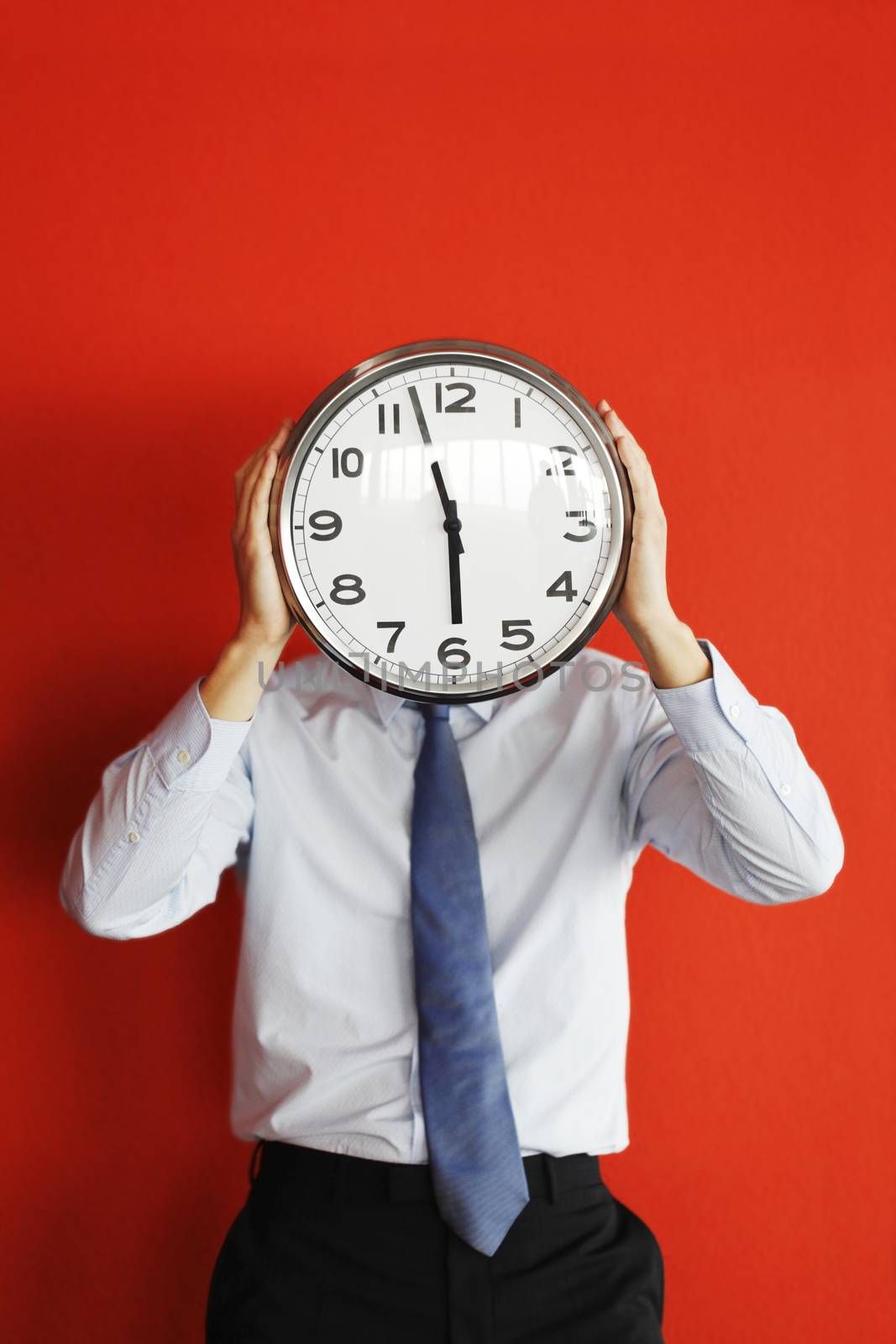 Man holding big clock covering face by ALotOfPeople