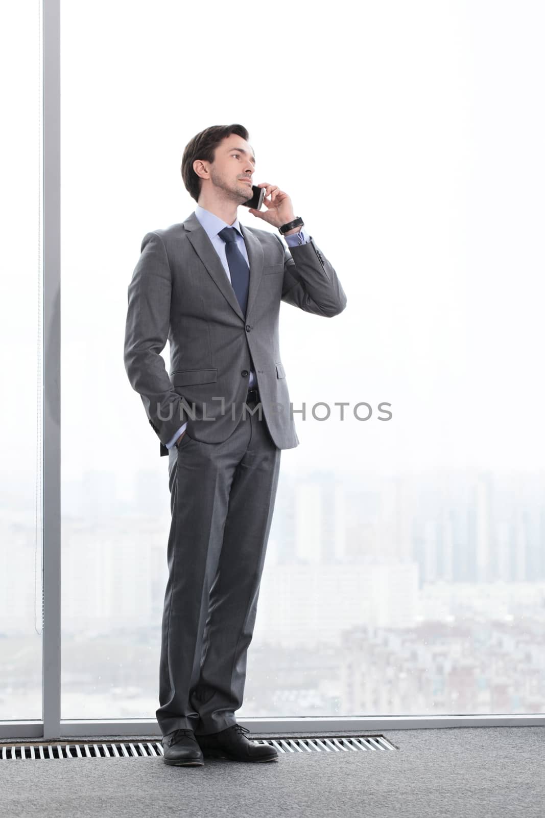 Businessman talking by phone by ALotOfPeople