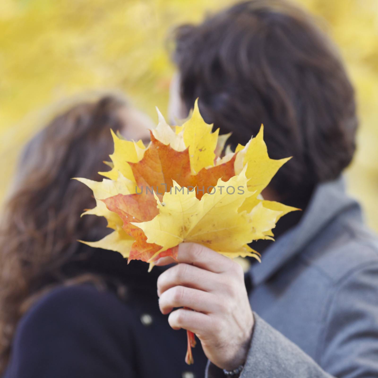 Couple kissing in autumn park, love, relationship, family and people concept