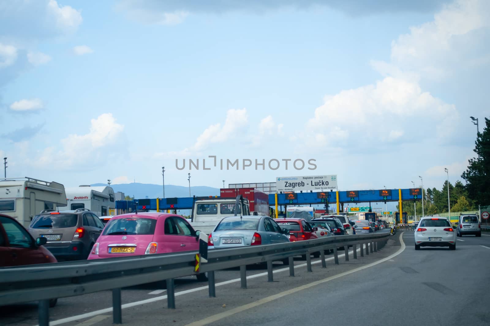 Heavy trafiic with congestions at Toll gate Lucko in Zagreb, Croatia during touristic season by asafaric