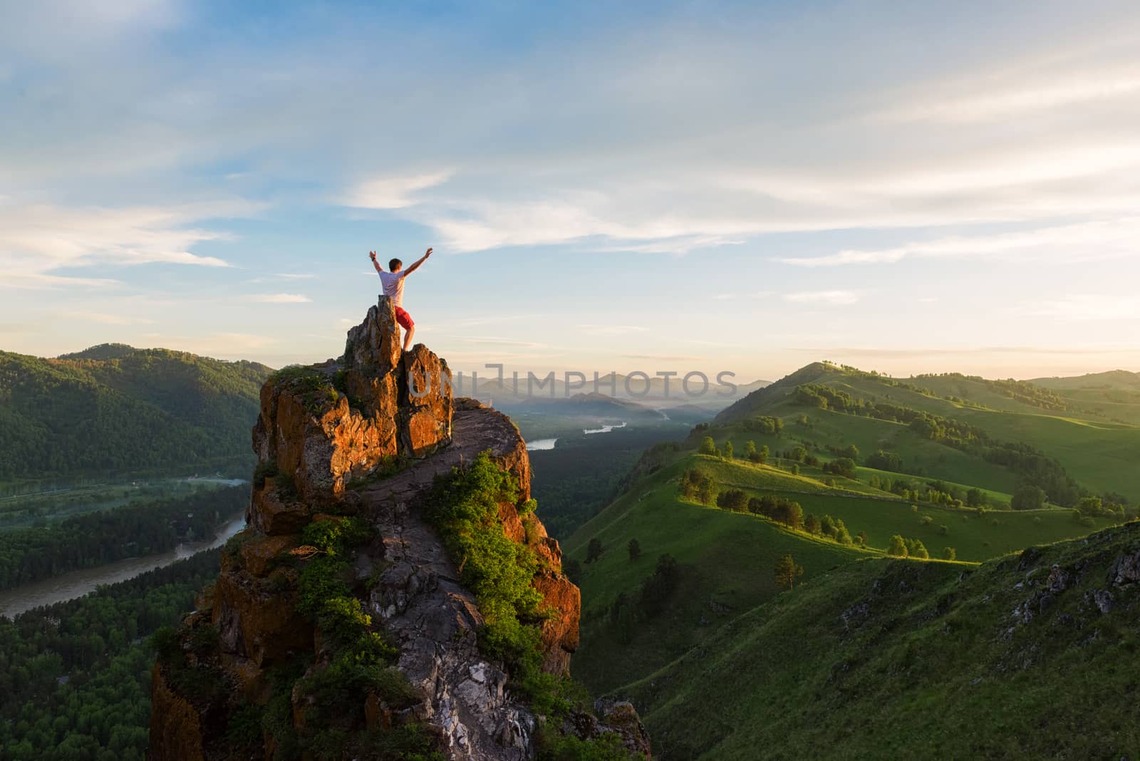 Man standing on top of cliff by rusak