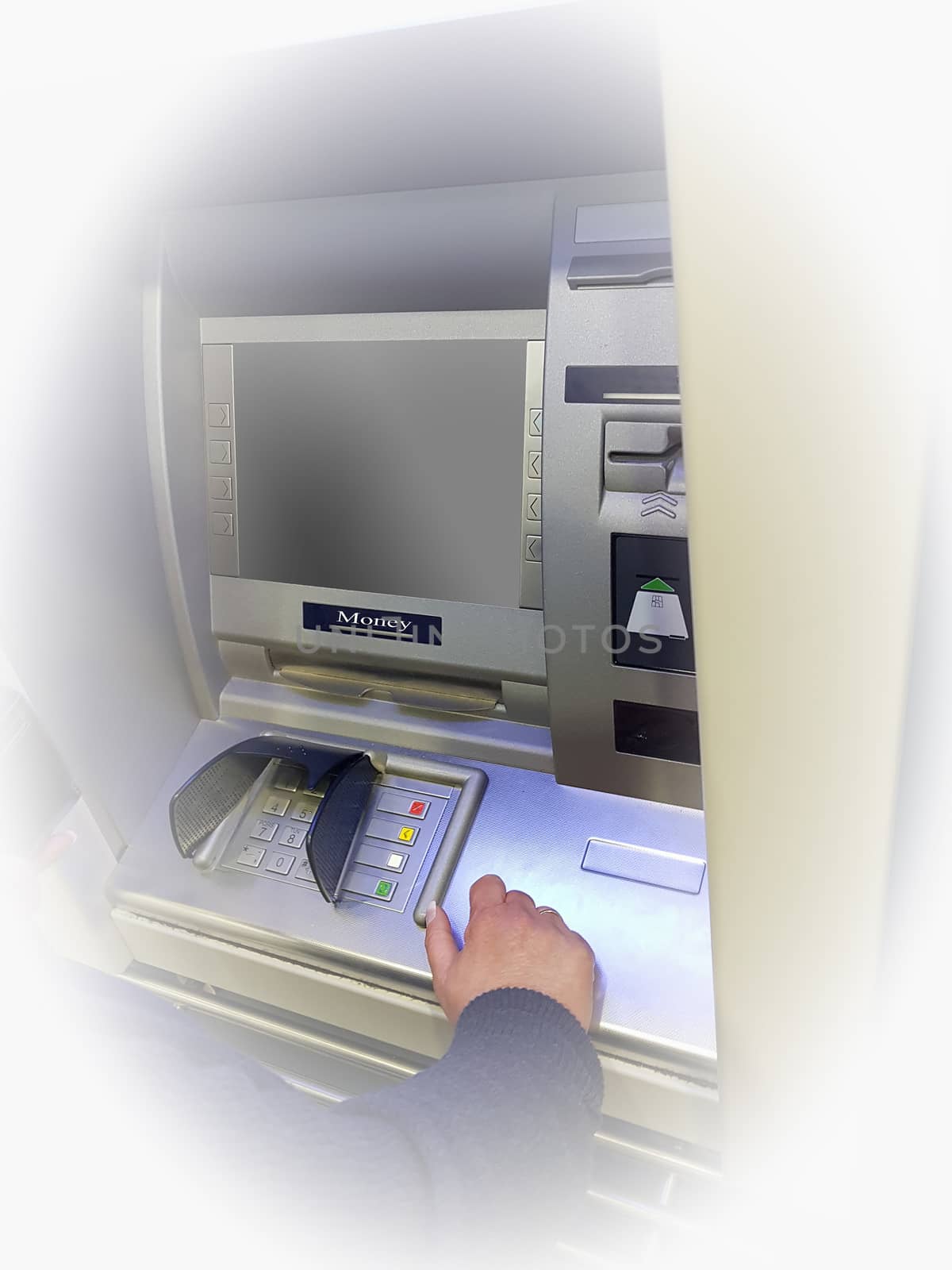 Woman at an ATM cash machine with vignetting