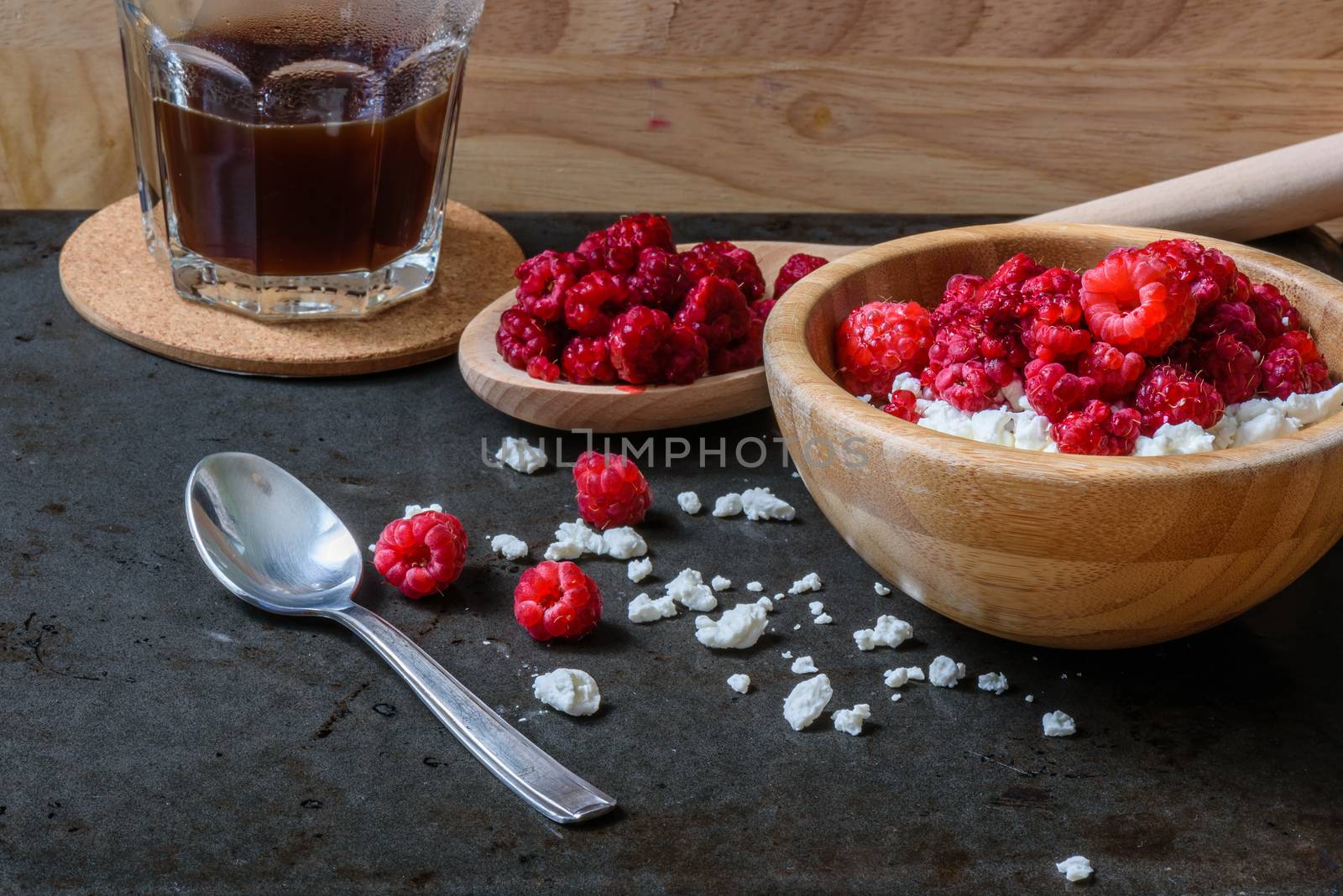 Cottage cheese with raspberries and cup of coffee for breakfast. with scattered berries and grains of curd