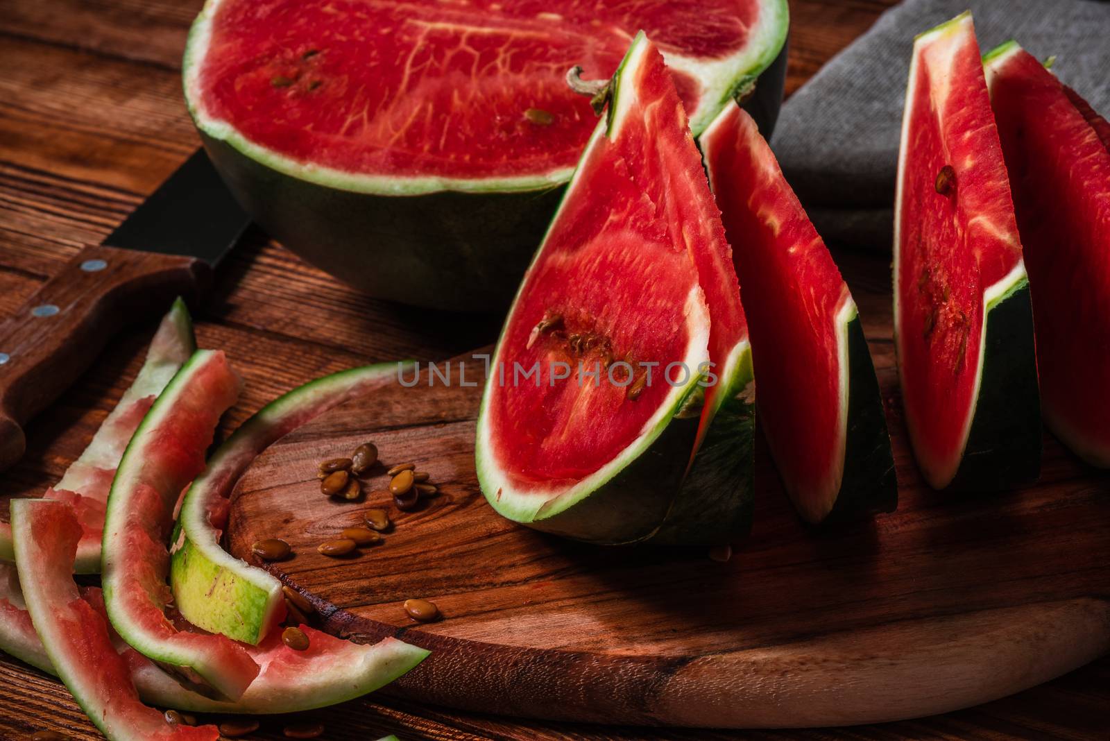 Watermelon slices and peels lying on cutting board by Seva_blsv