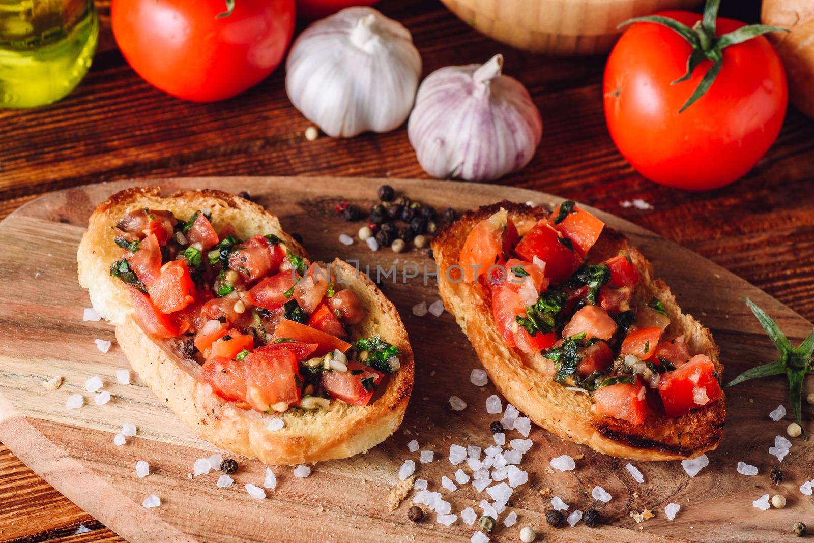 Classic Italian Bruschetta with Tomatoes and Some Ingredients on Background