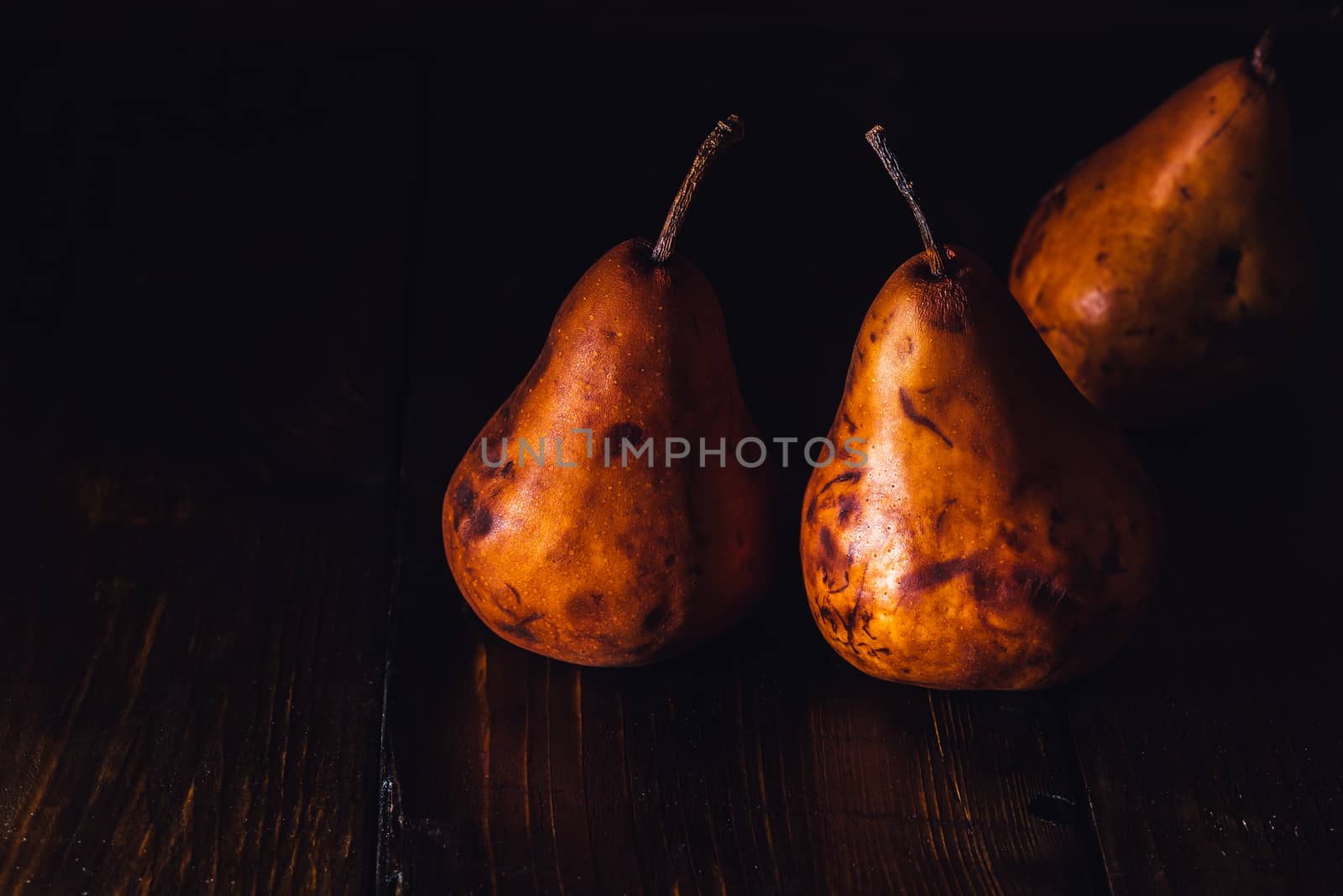 Golden Pears on Wooden Table by Seva_blsv