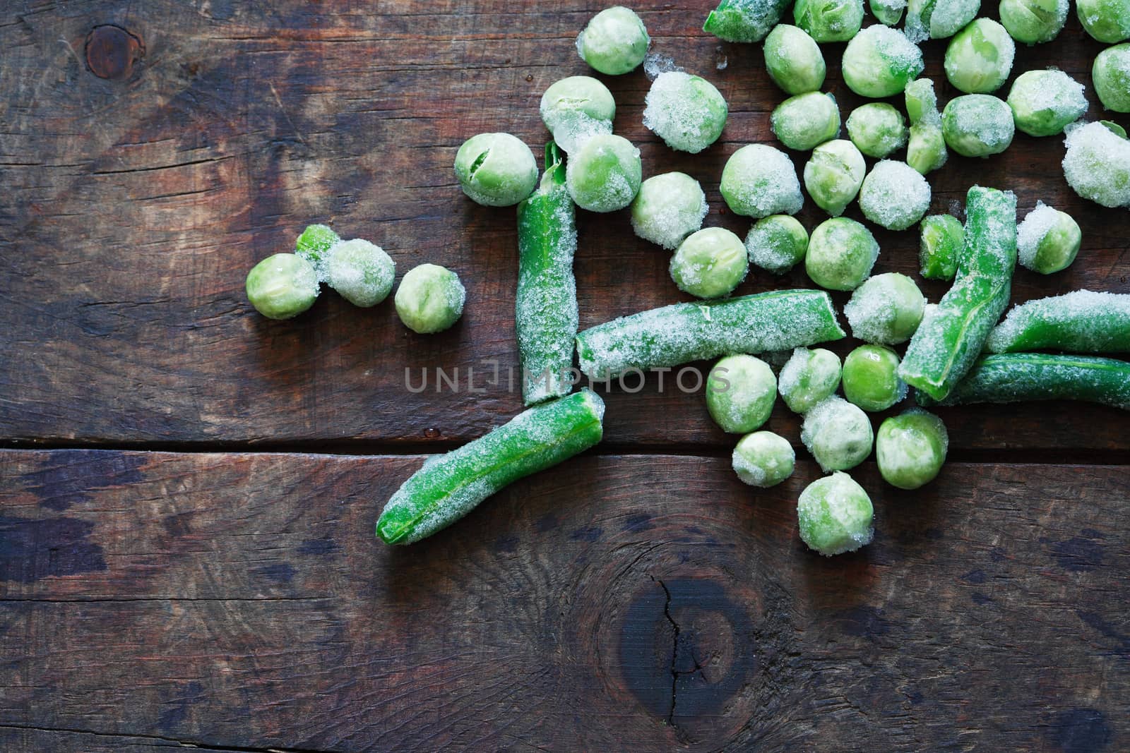 Frozen bean and pea closeup on old wooden background