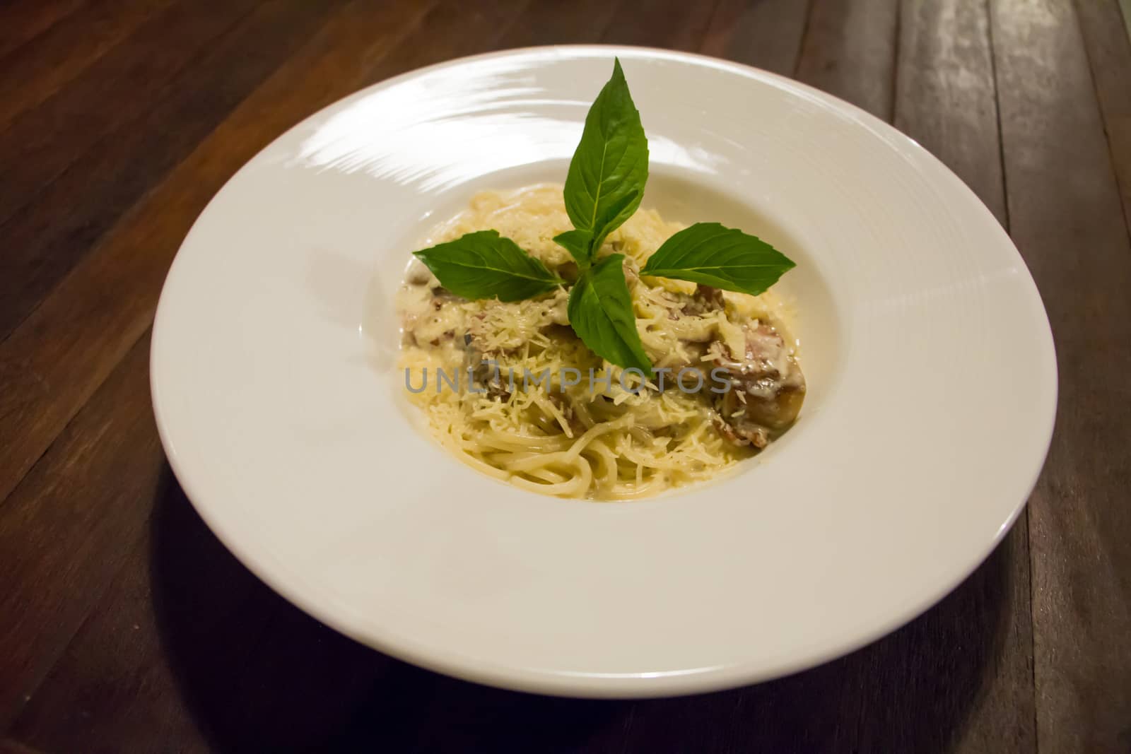 Spaghetti Cream with Becon and Mushroom on white plate