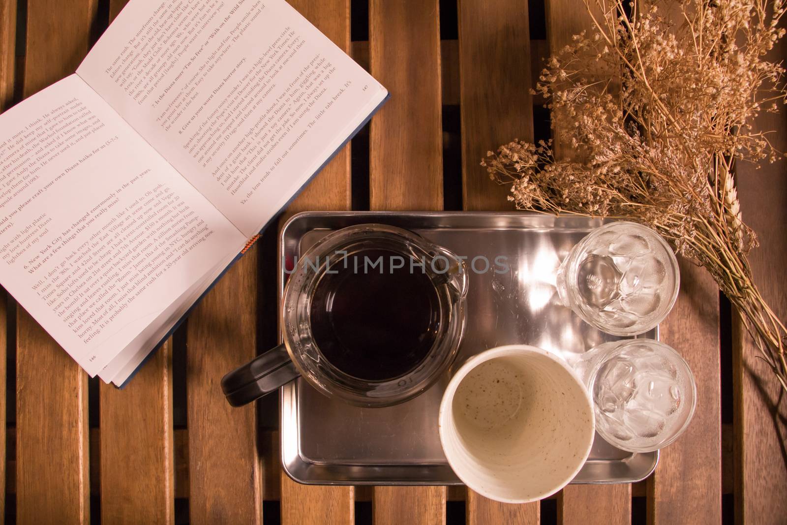 Flat Lay Drip Coffee on wooden plate with open book