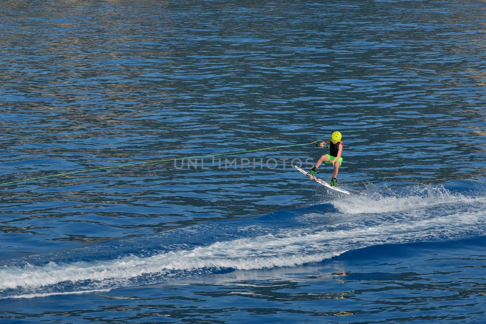 Little boy Wakeboarding on summer sea