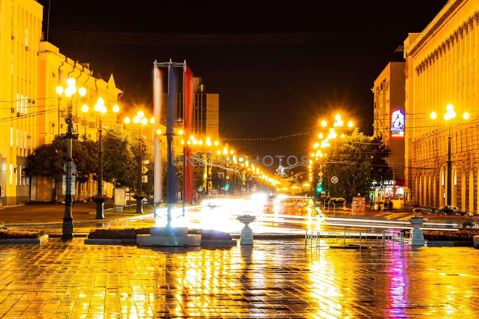 Night city landscape. The main square of the city of Khabarovsk in the light of lanterns, which are reflected in puddles after the rain just passed.