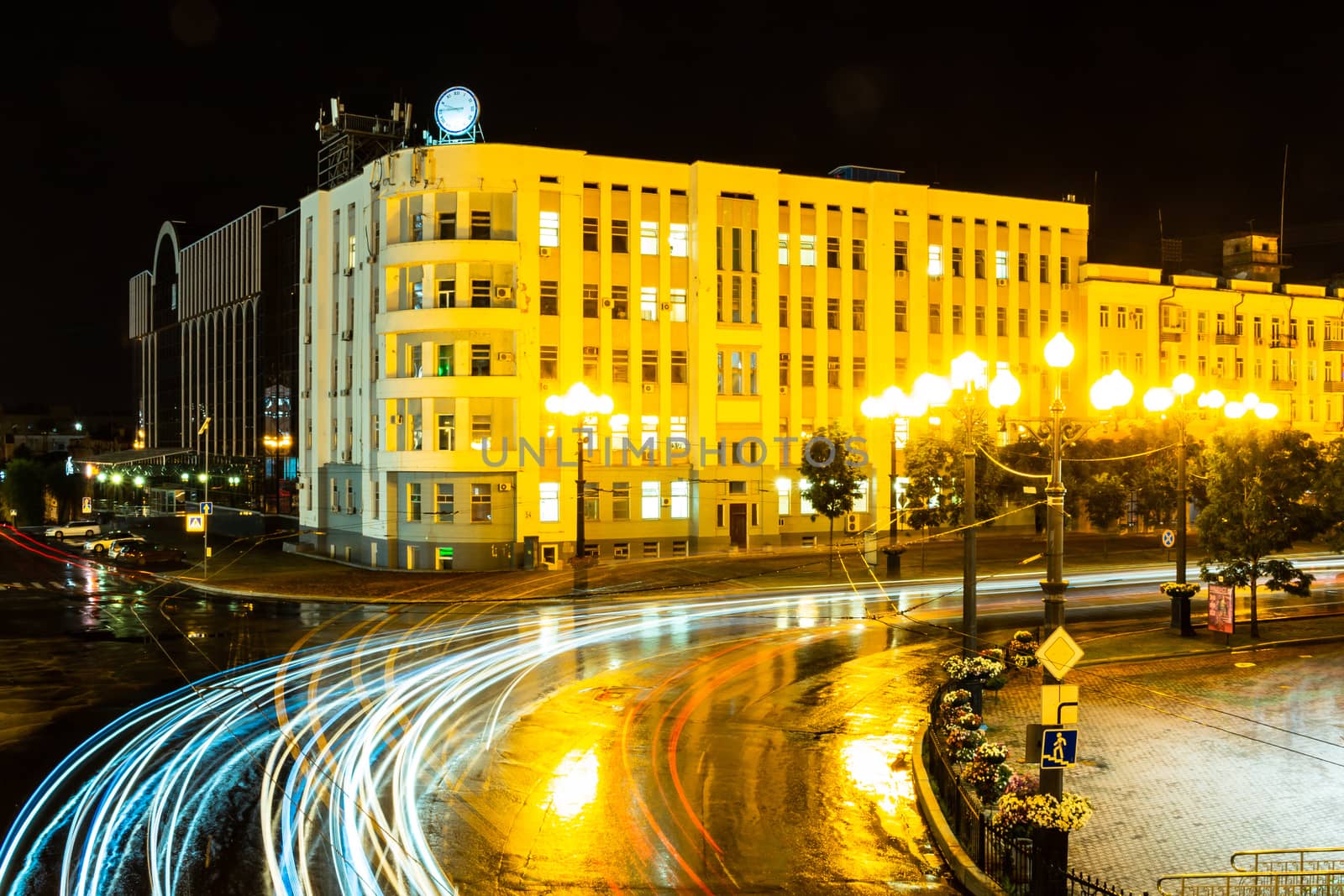Night city landscape. The main square of the city of Khabarovsk in the light of lanterns, which are reflected in puddles after the rain just passed.