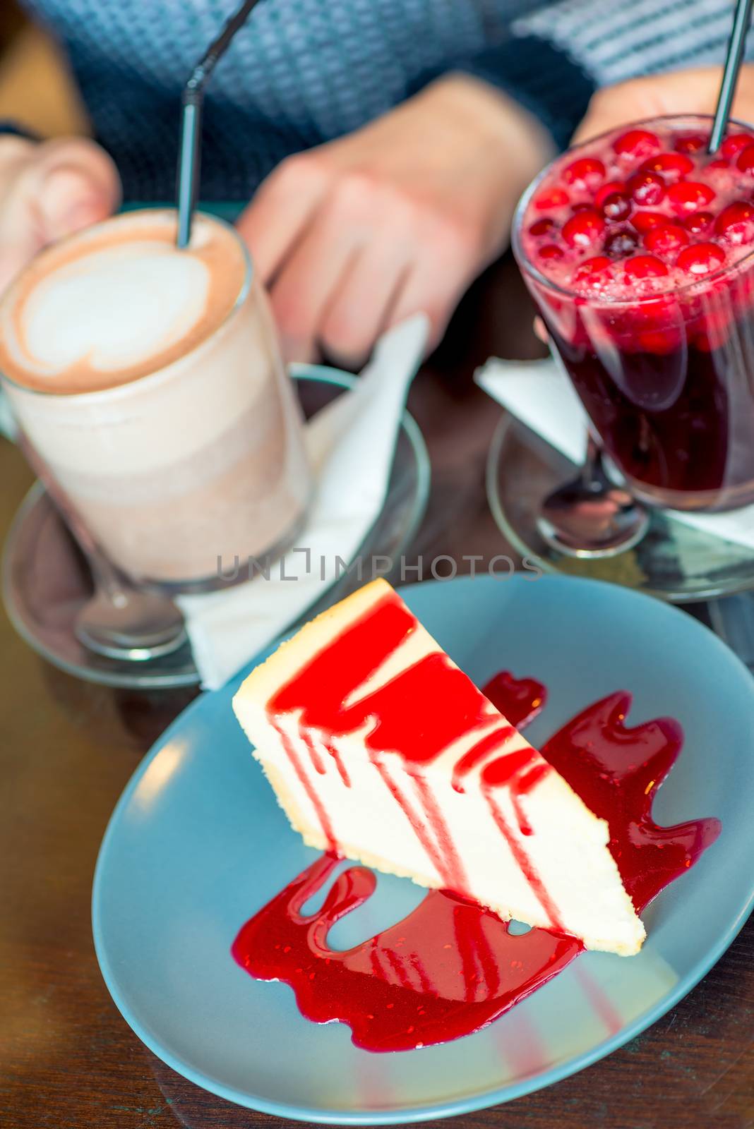 Delicious strawberry cheesecake and hot drinks in a close-up cafe