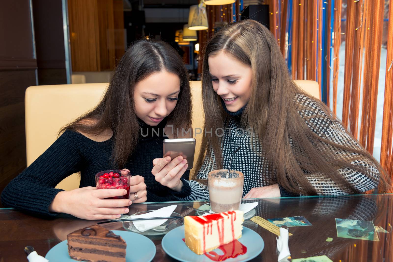 Portrait of good friends in a cafe with dessert and coffee