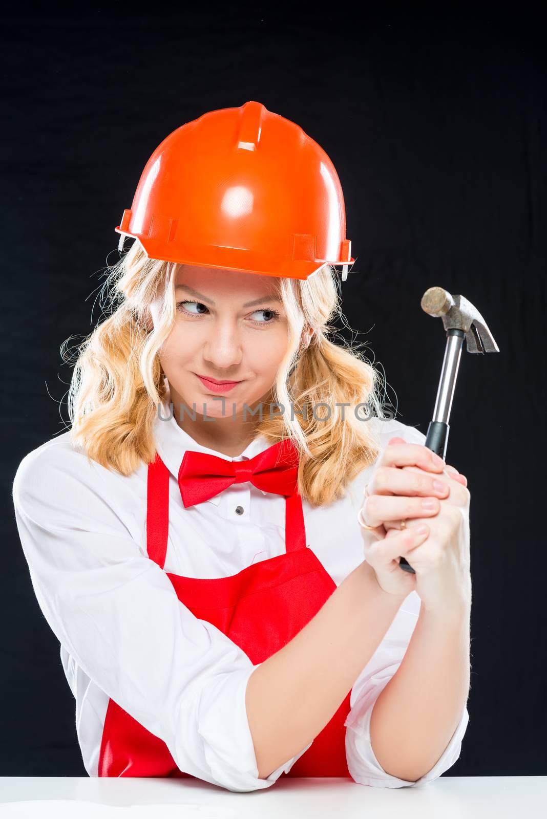 Crazy cook in helmet with a hammer on a black background