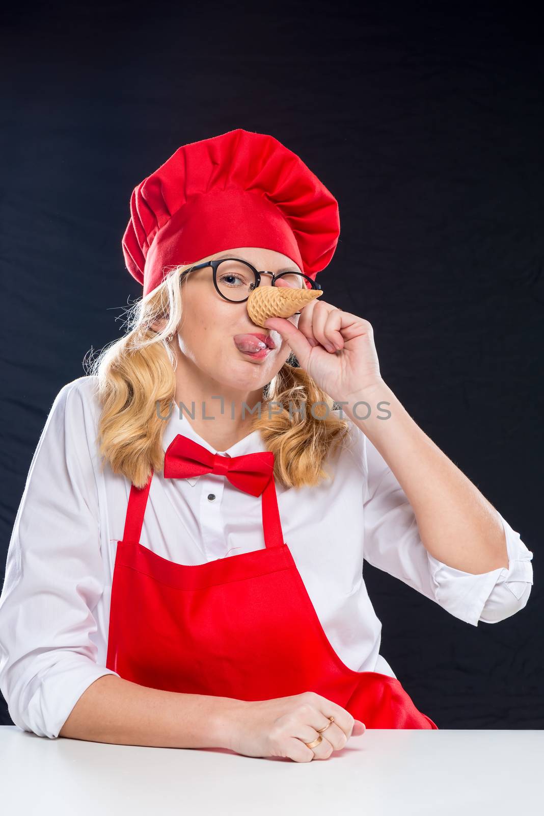 Woman animator with waffle cup for ice cream grimaces on black background