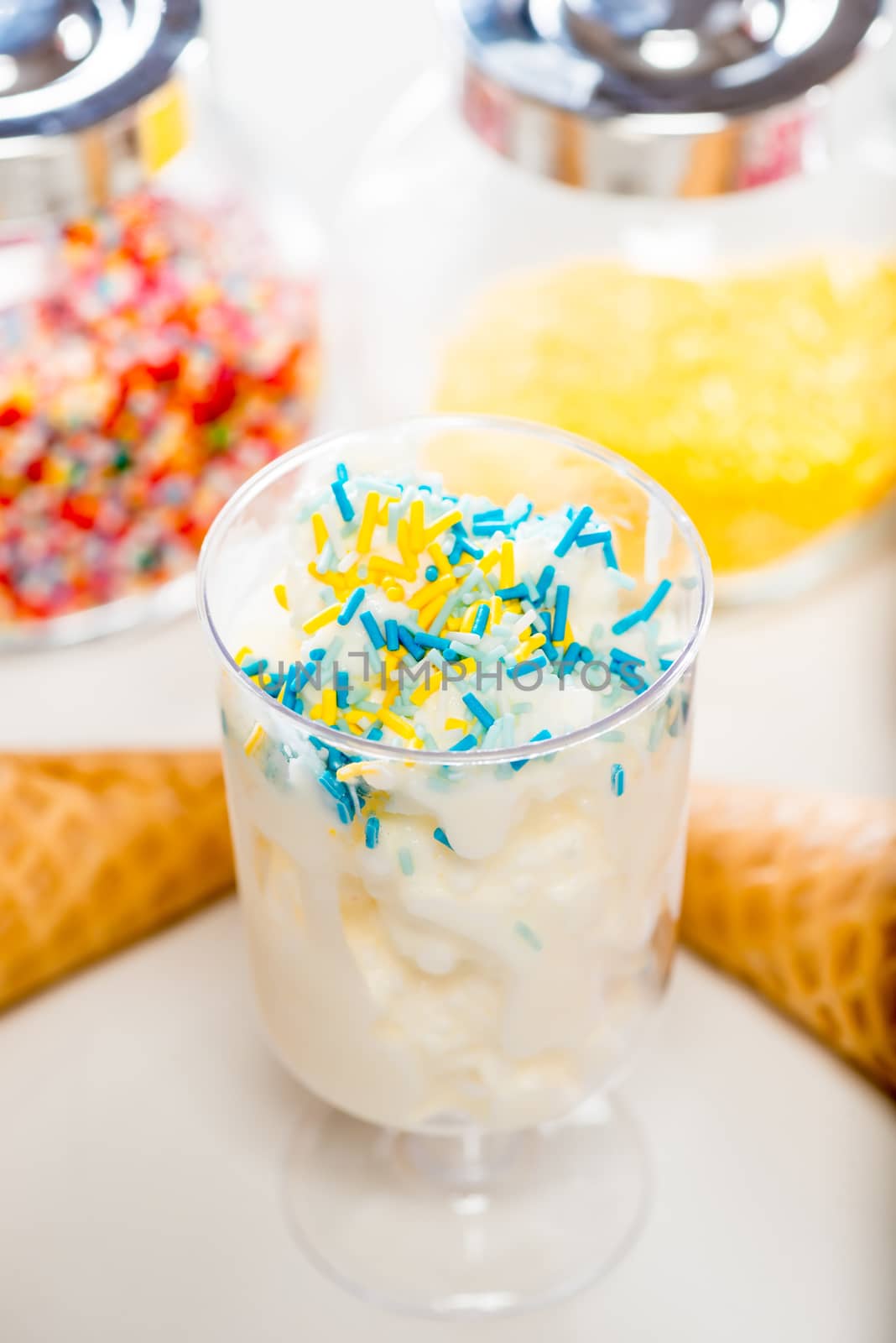 Close-up of a glass with cream ice cream and decorative sprinkle by kosmsos111