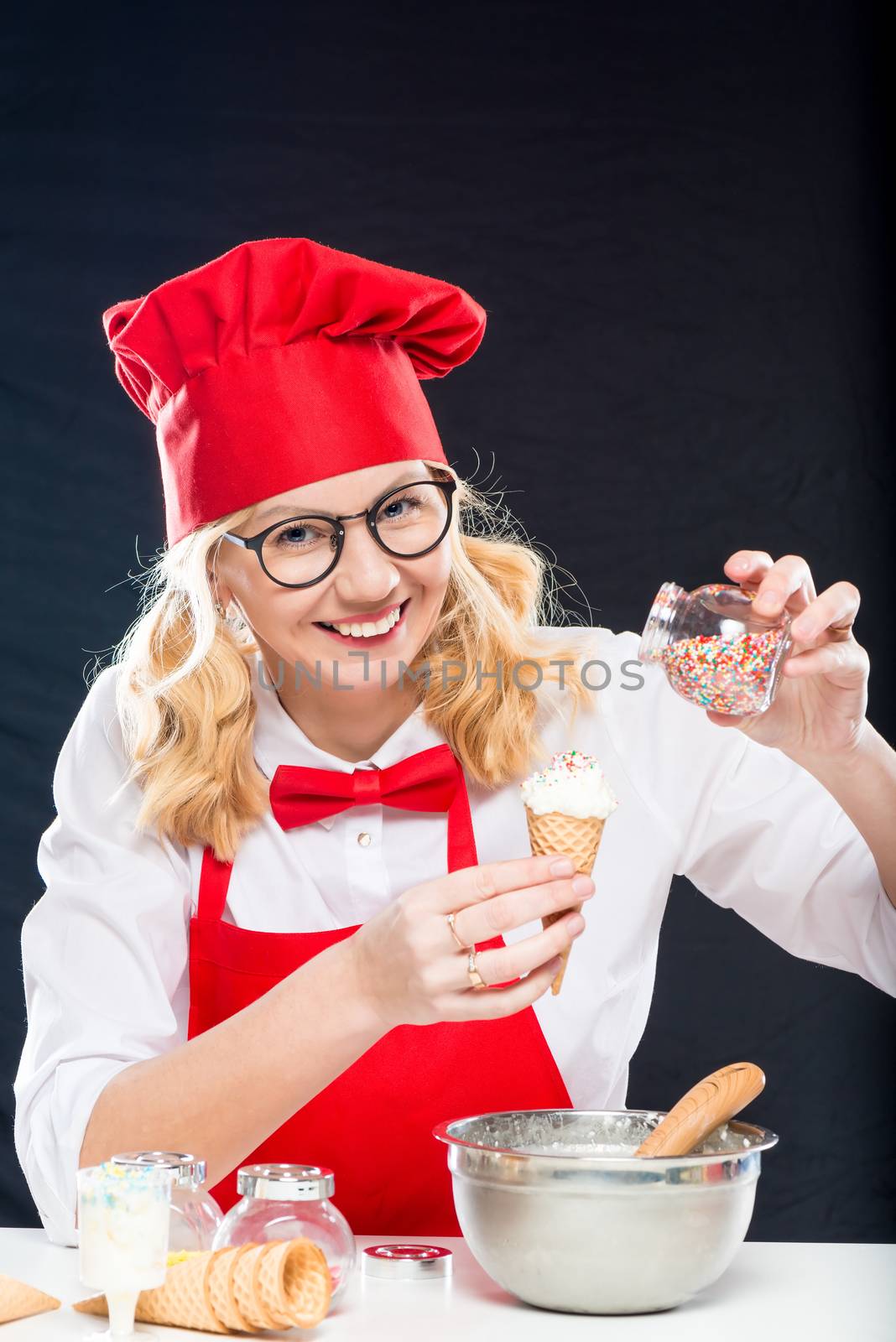 Happy chef with ice cream in a waffle horn, makes a decor