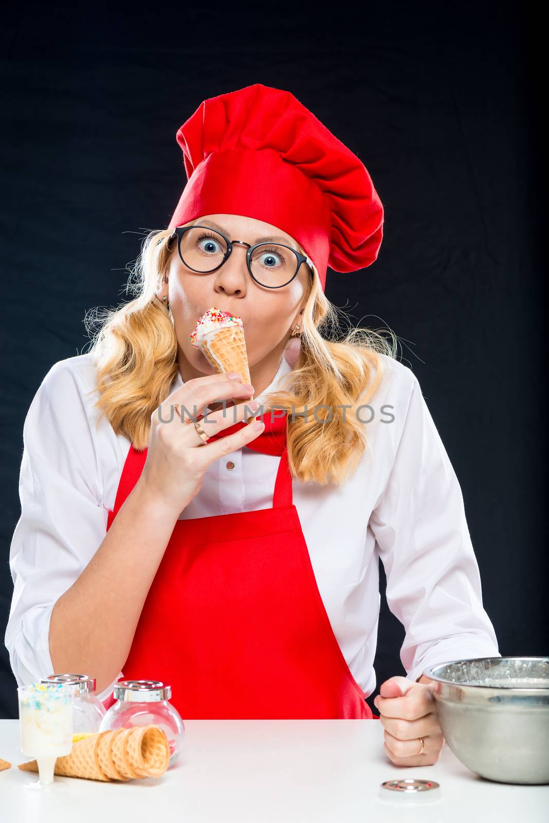 Girl with ice cream on a black background, homemade ice cream