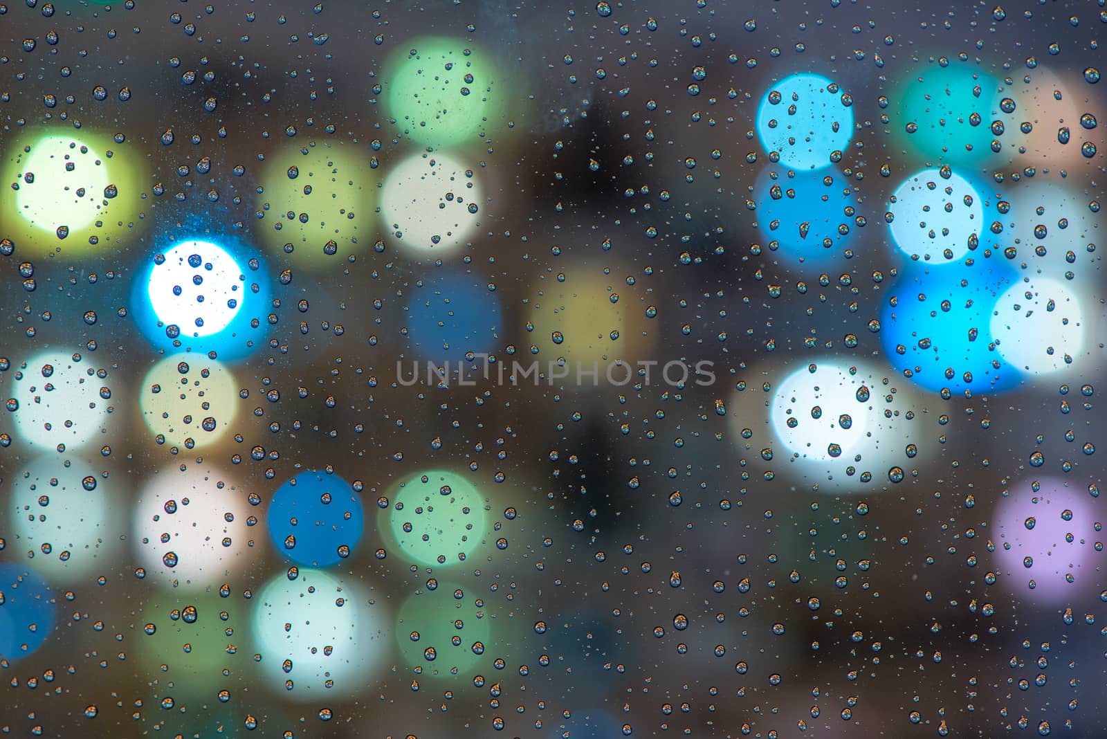 Glass with raindrops close-up macro, in the background lights by kosmsos111