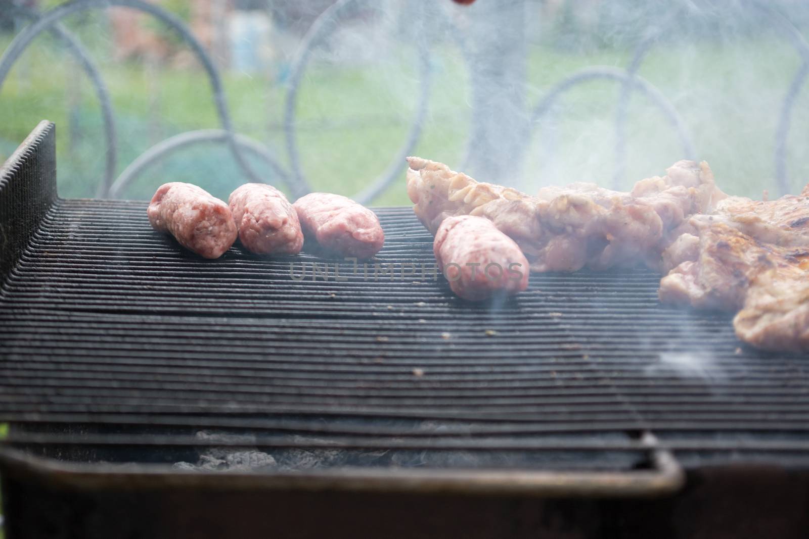 Grilling cevapi and pork chops.