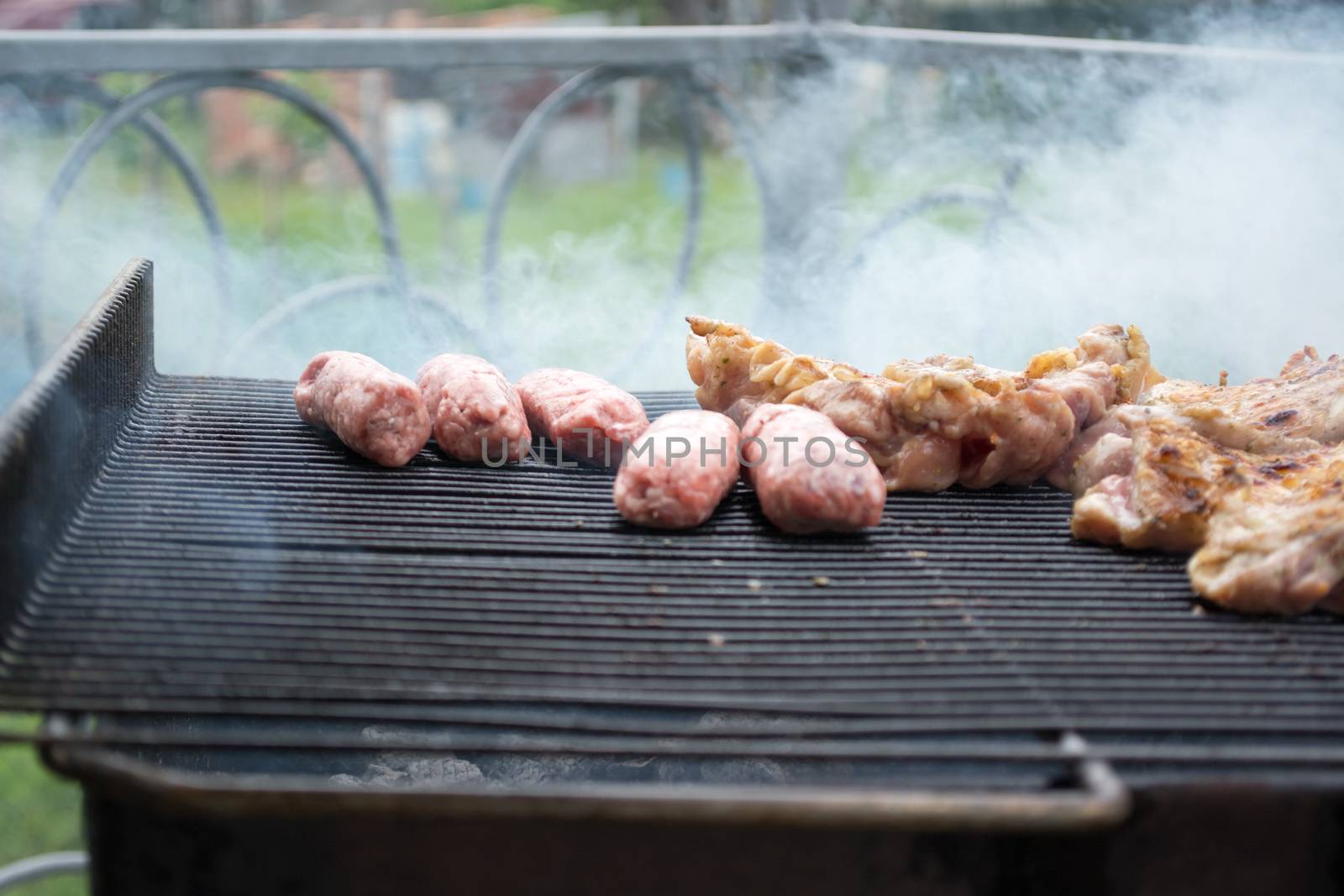 Grilling cevapi and pork chops.