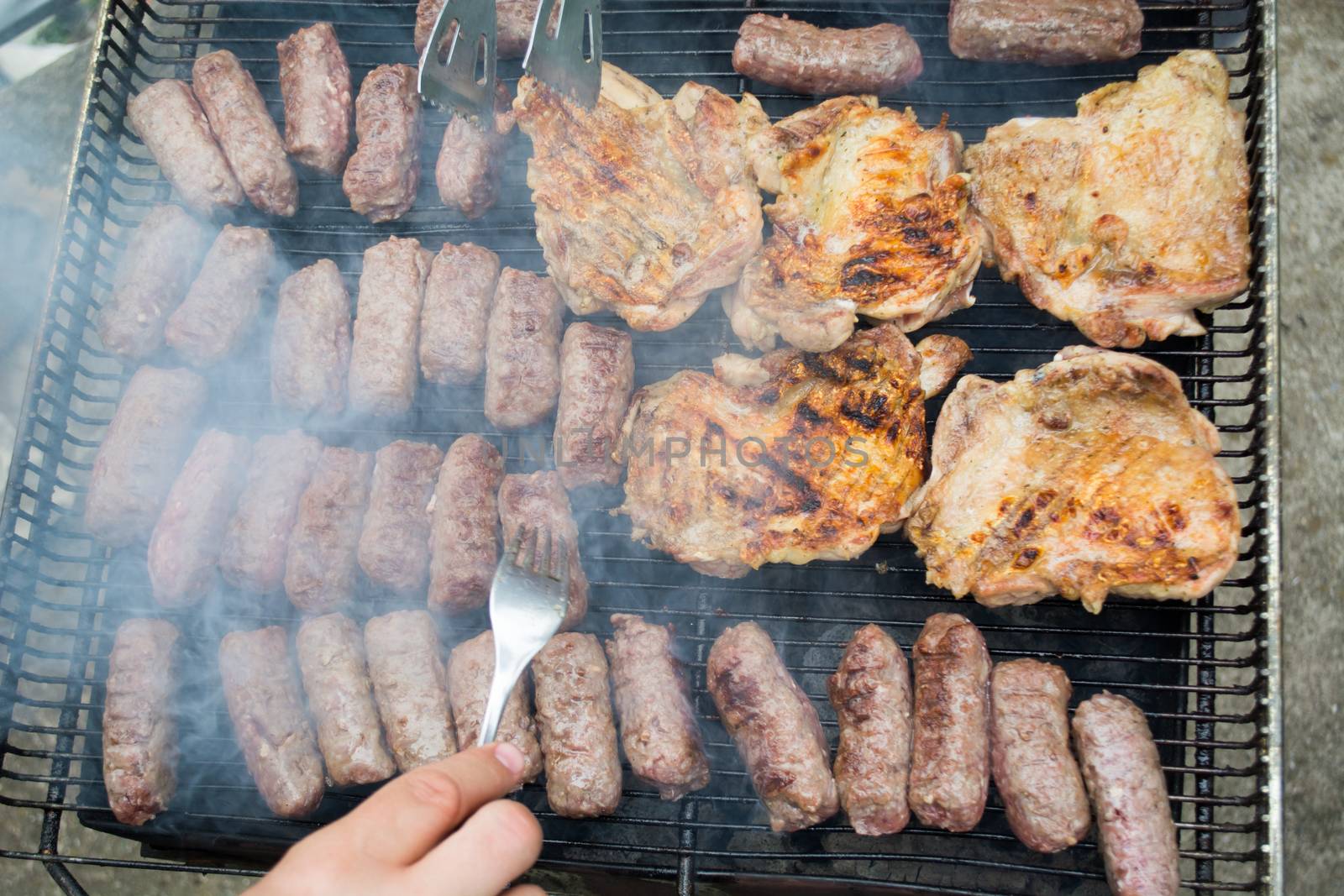 Grilling cevapi and pork chops.