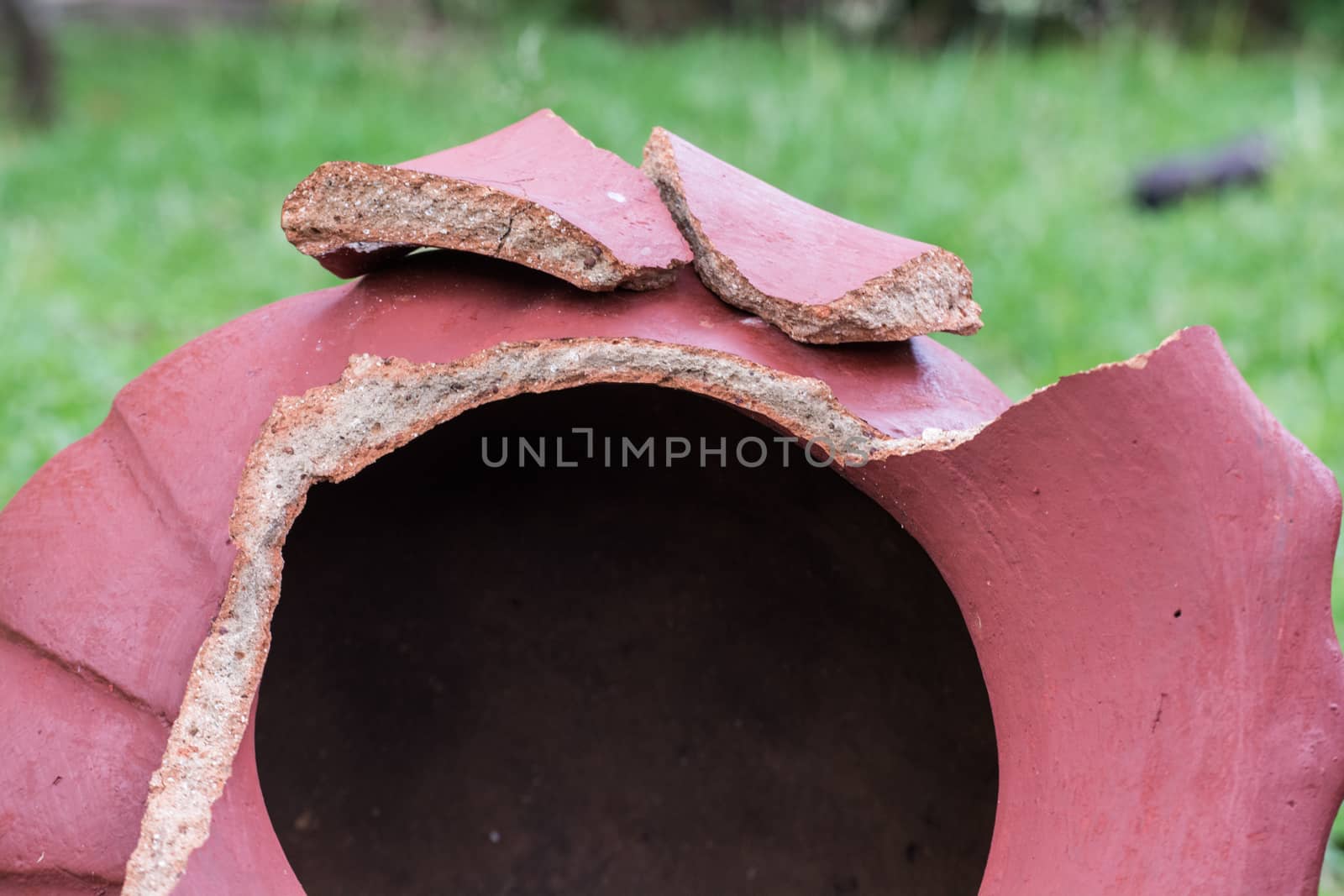 Close Up of Broken And Red Ceramic in a Garden Outdoor by Kinetoscope