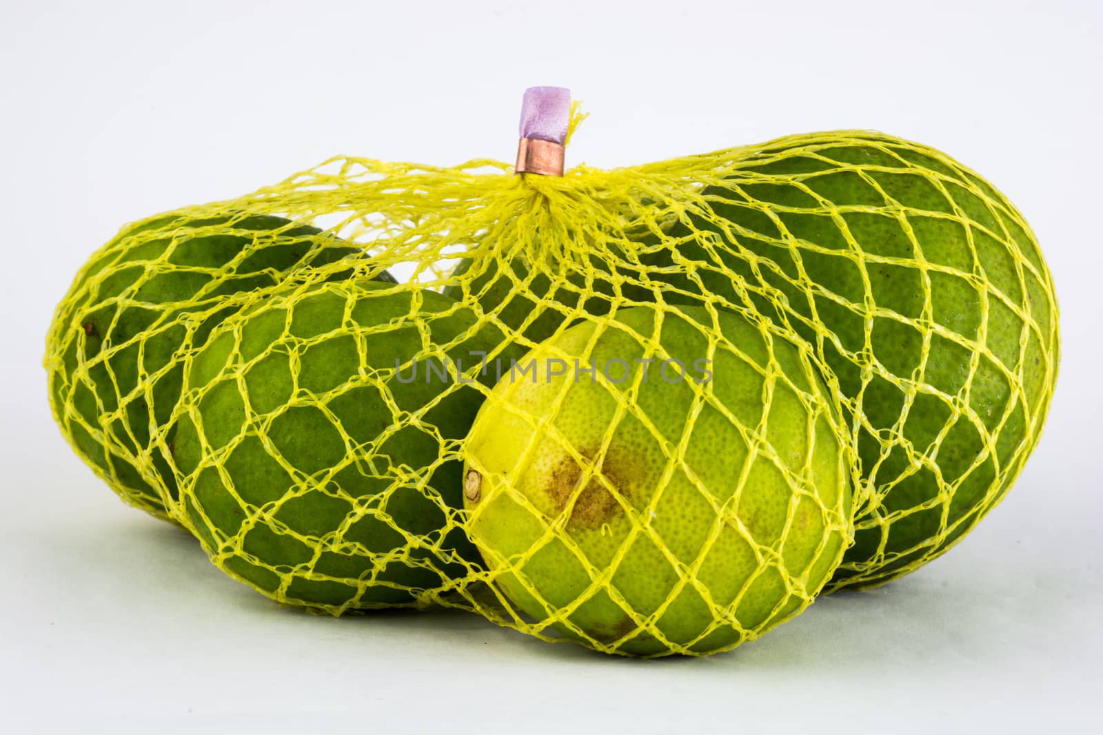 High resolution and quality photo of lemons in yellow net by Kinetoscope