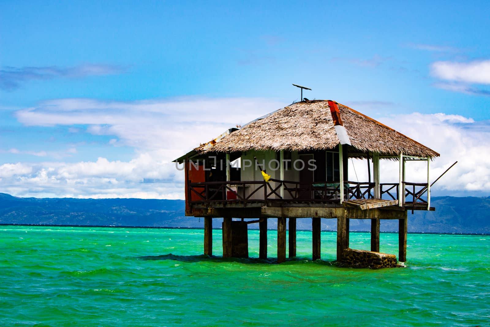 On the spit are houses on stilts. Water during the surf rises, cutting off the scythe from the land.