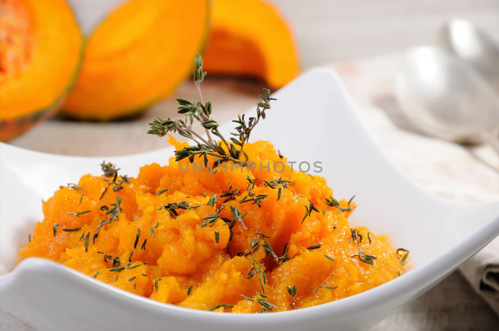 Baked pumpkin with a tender, juicy pulp flavored with thyme. Close-up.